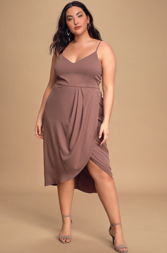 Model wearing mauve colored midi dress with thin straps and wrap body