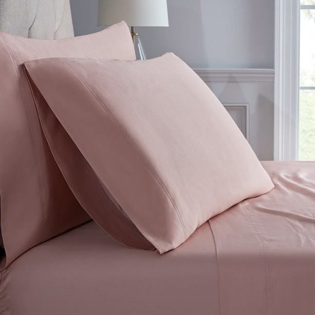 the pink sheets on a bed