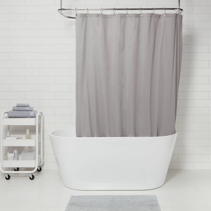 a gray heavy shower liner in a white tub