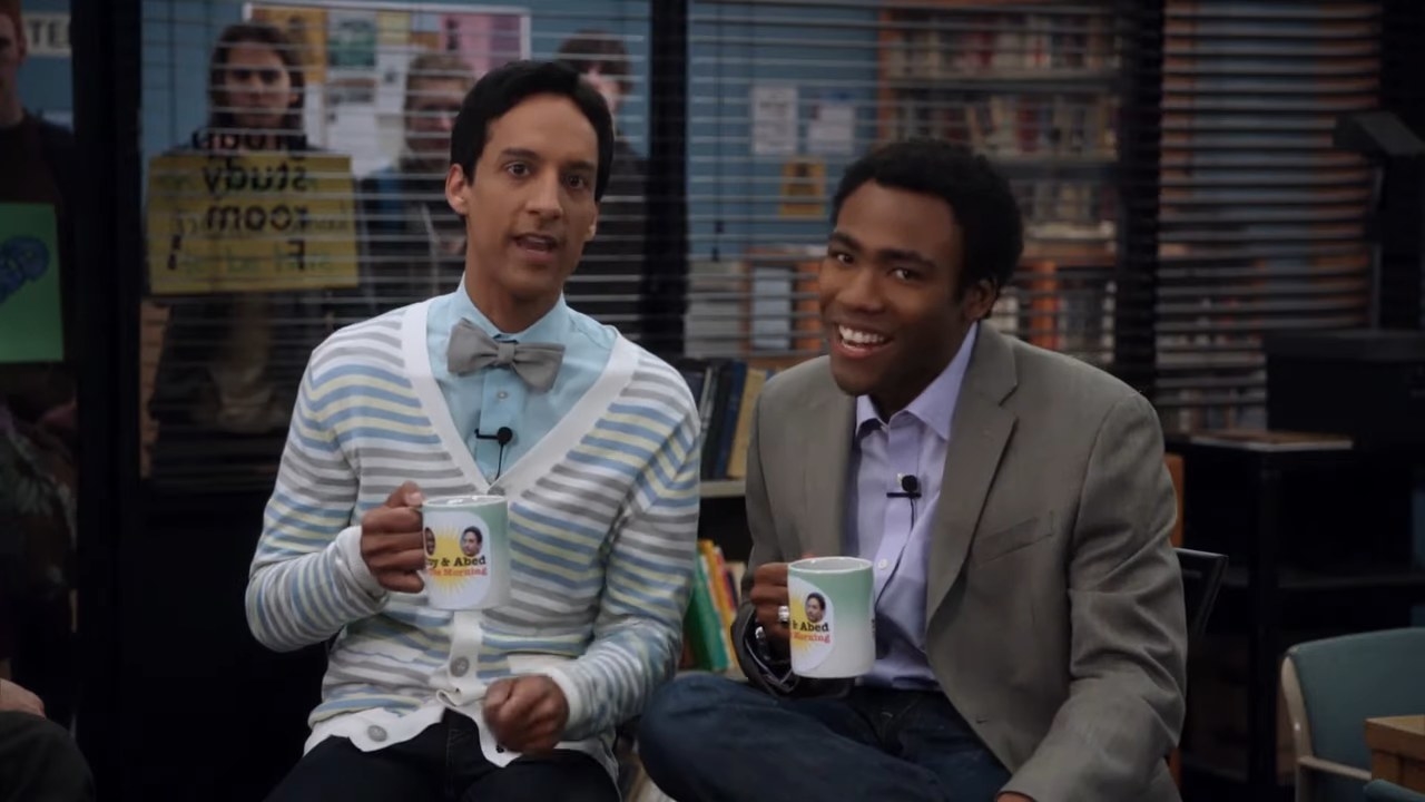 Troy and Abed holding coffee mugs on their imaginary talk show in &quot;Community&quot;