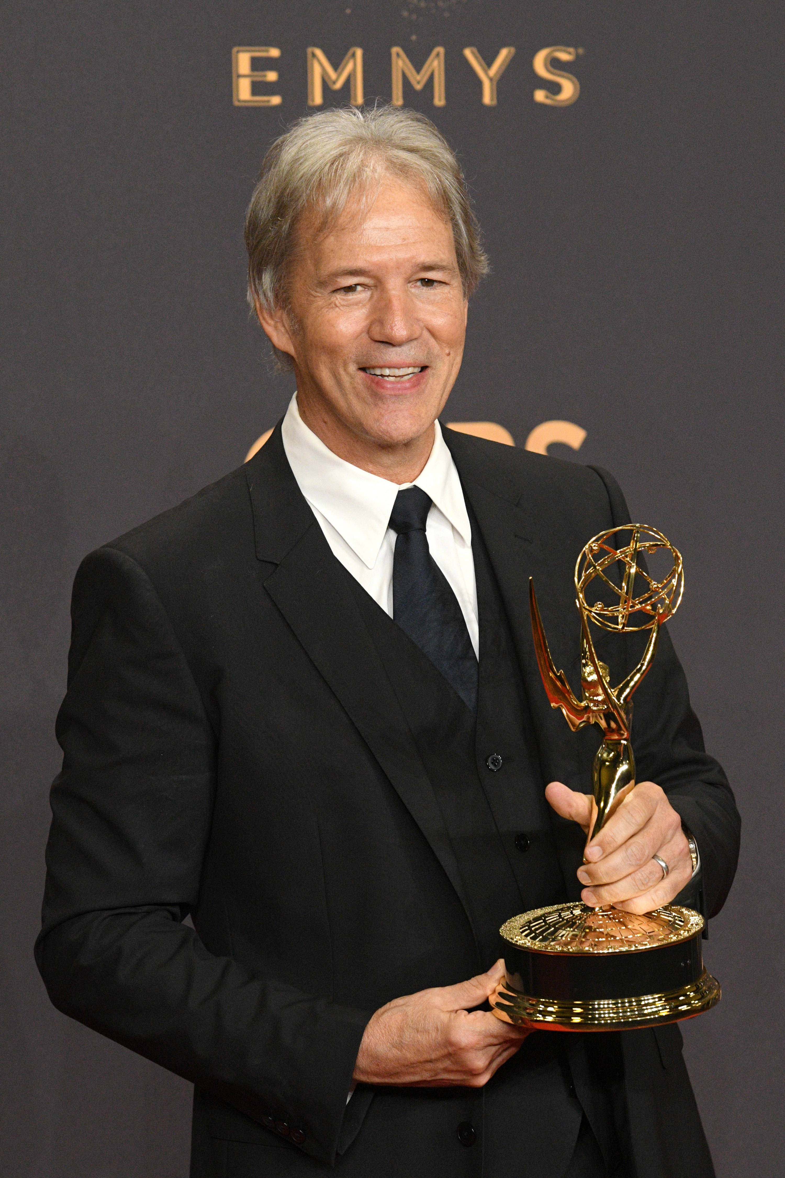 David E. Kelley with an Emmy Award