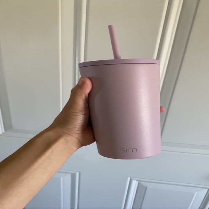 a reviewer holding their tumbler in lavender