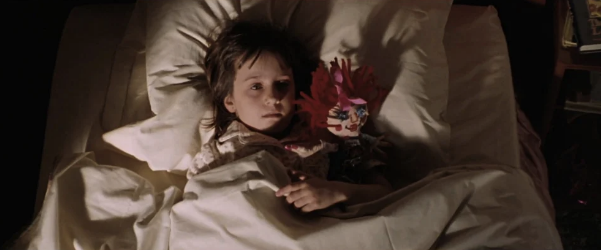 Matilda in bed holding the doll