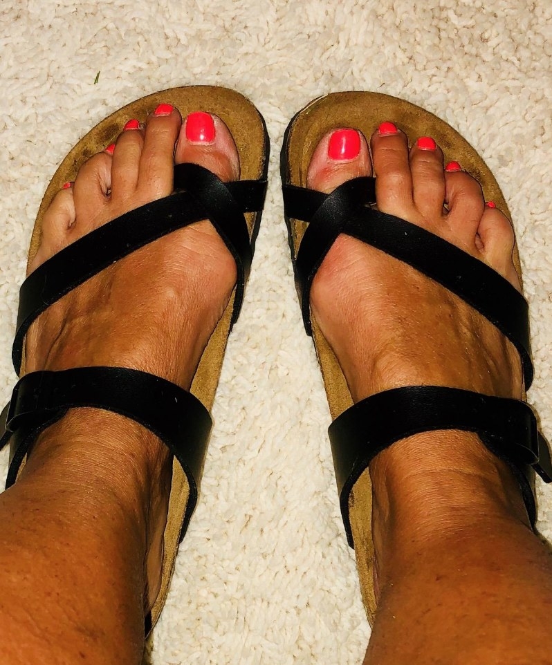 Reviewer wearing black crossband birkenstock sandals