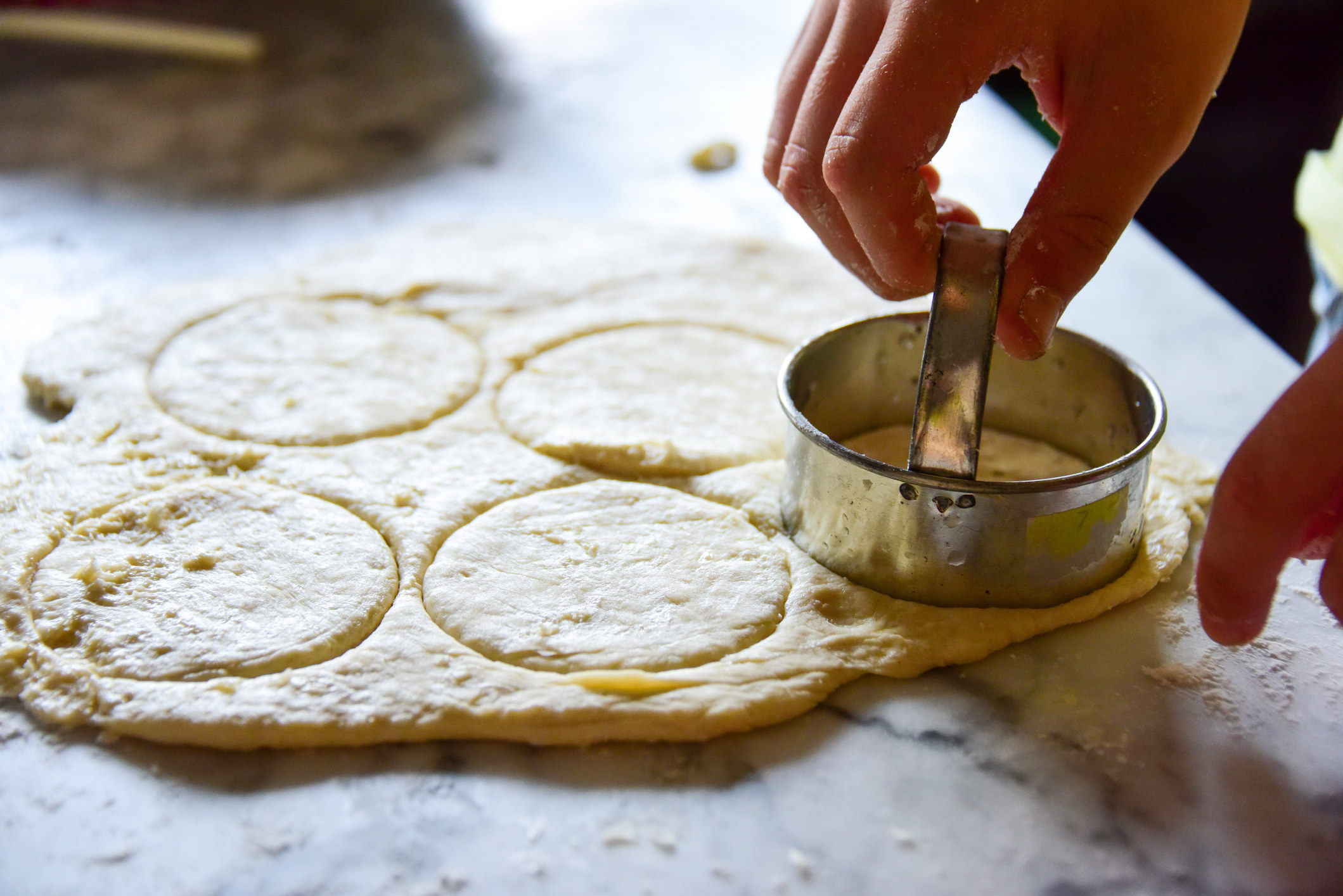 Cutting circles out of dough.
