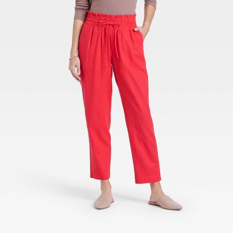 a model wearing the pants in red