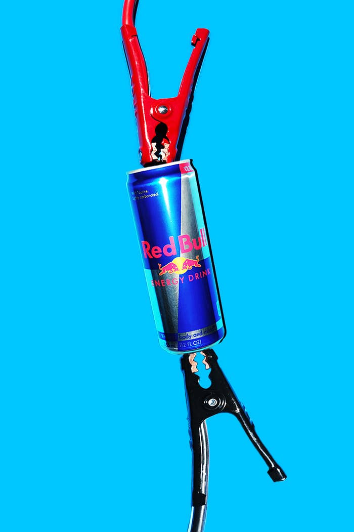 An image of a can of Red Bull attached to car jumper cables.