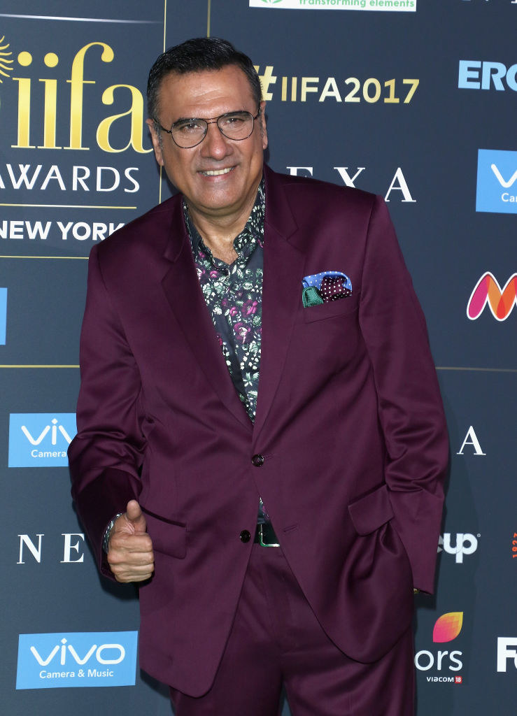 A bespectacled Boman Irani smiles and poses with a thumbs up