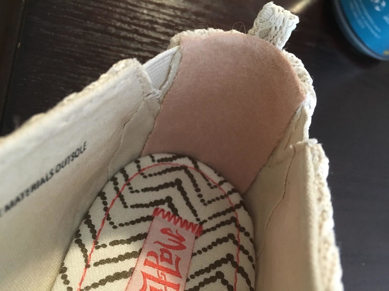 Reviewer&#x27;s photo of their shoe with moleskin attached in the heel