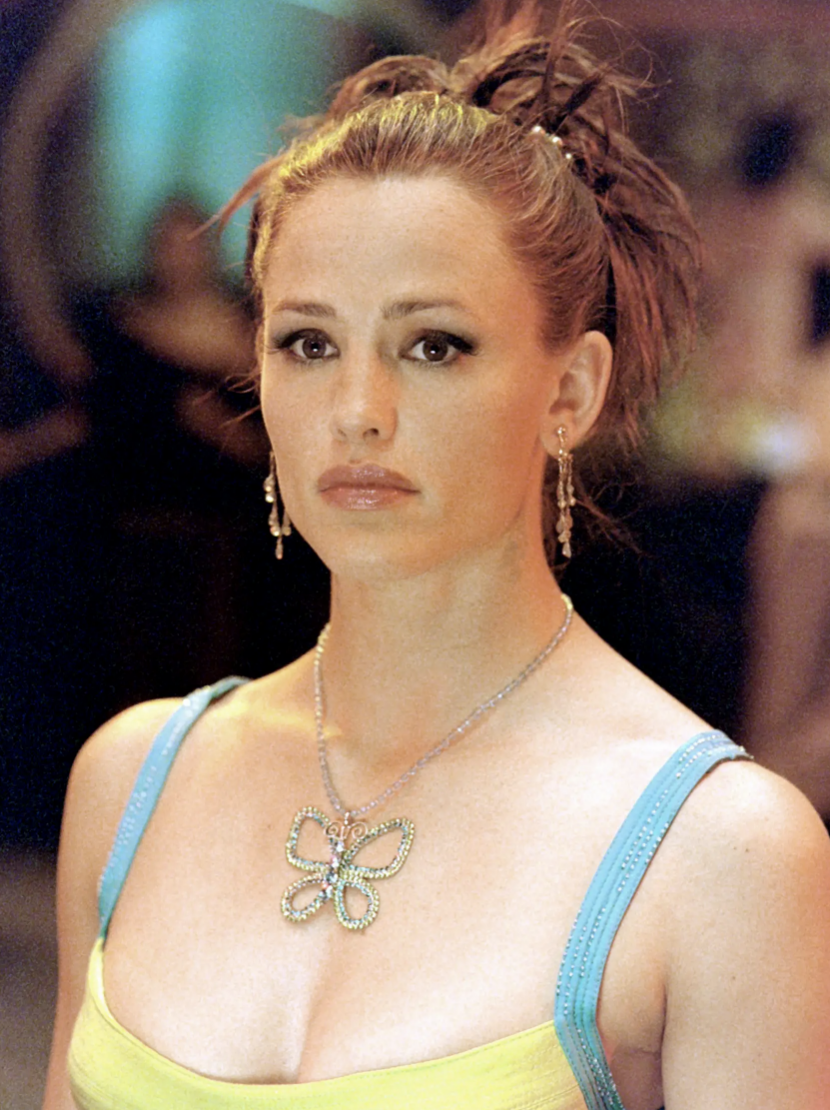 Jennifer in a spaghetti-strap top, earrings, and an updo