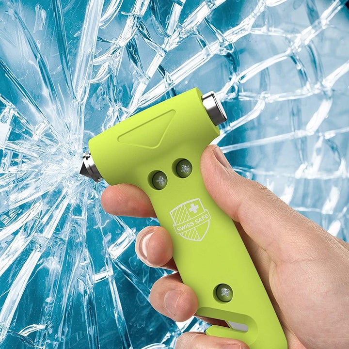 someone using the emergency tool to break glass
