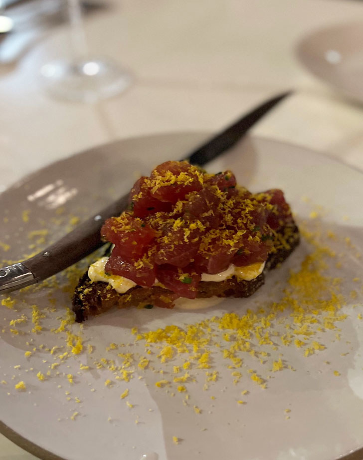 A piece of sourdough topped with tuna tartare.