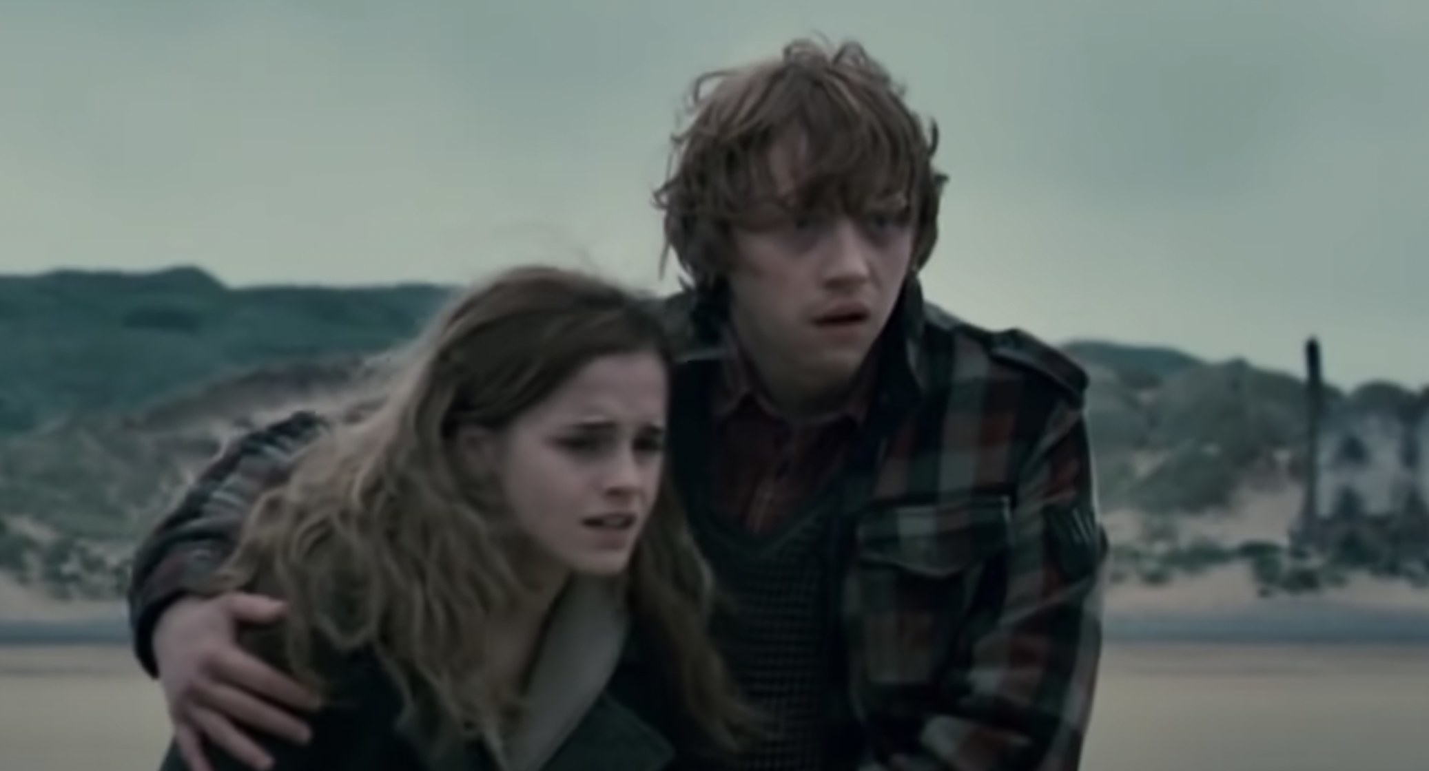 Hermione and Ron embracing and looking anguished