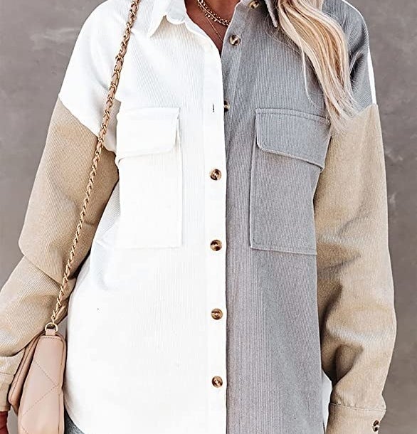 A person wearing the shacket buttoned up with a purse on their shoulder