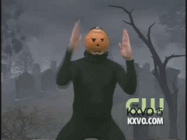 A news reporter with a pumpkin head dancing
