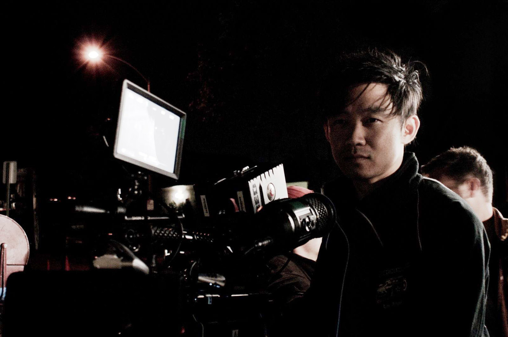 James Wan stands before his camera