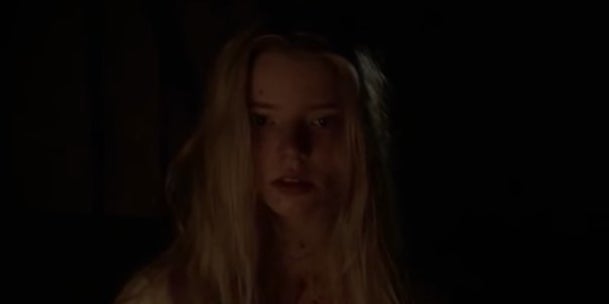 A close-up of Thomasin in the dark in &quot;The Witch&quot;