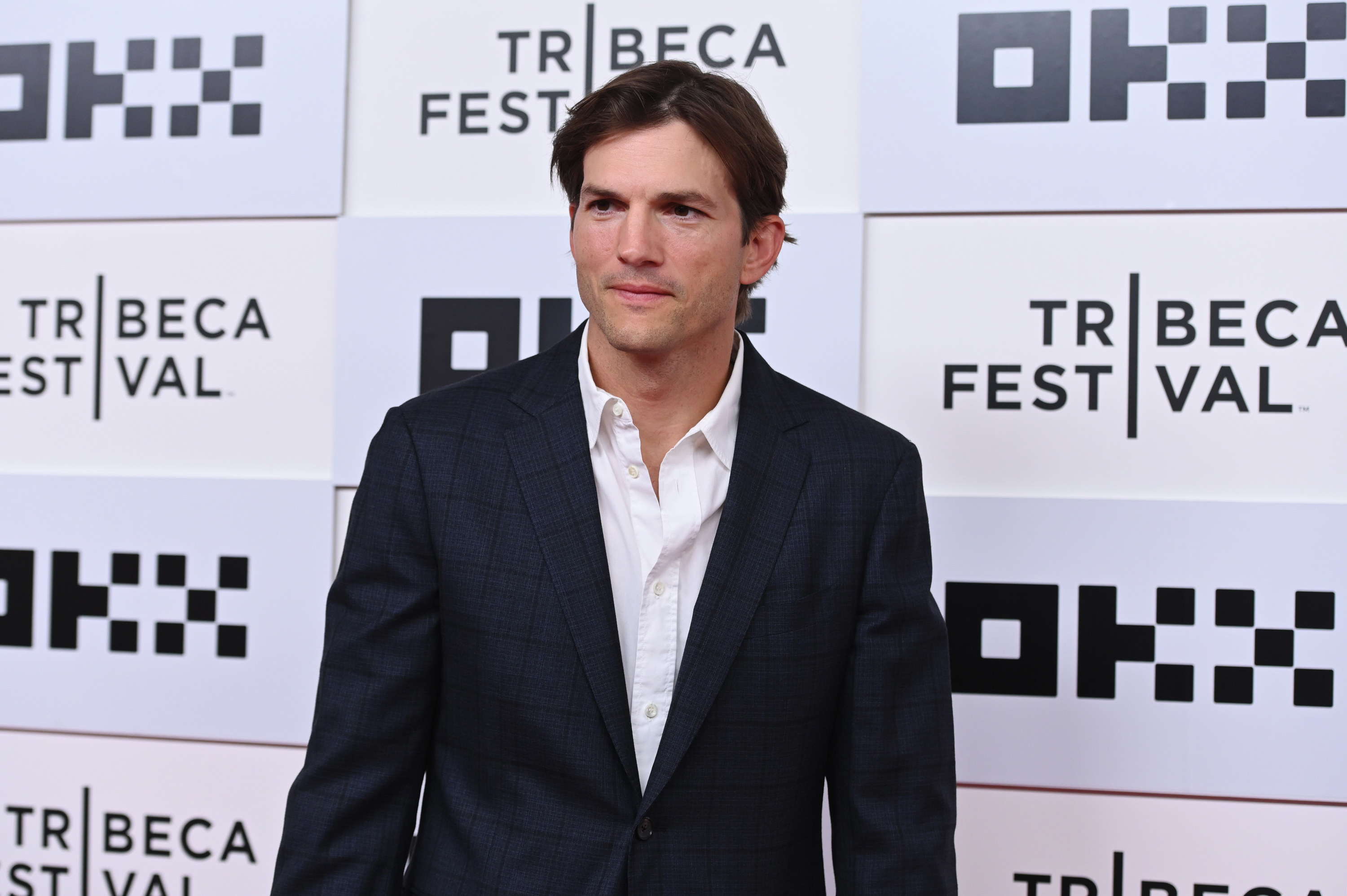 ashton kutcher posing at the tribeca film festival