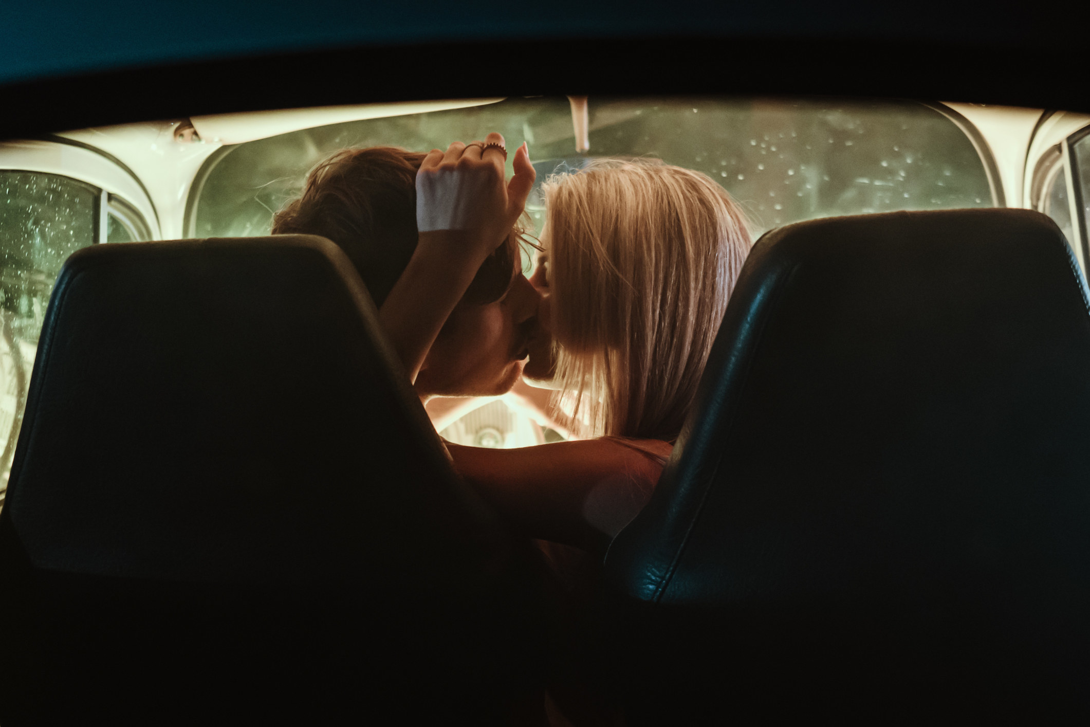 couple kissing in a car