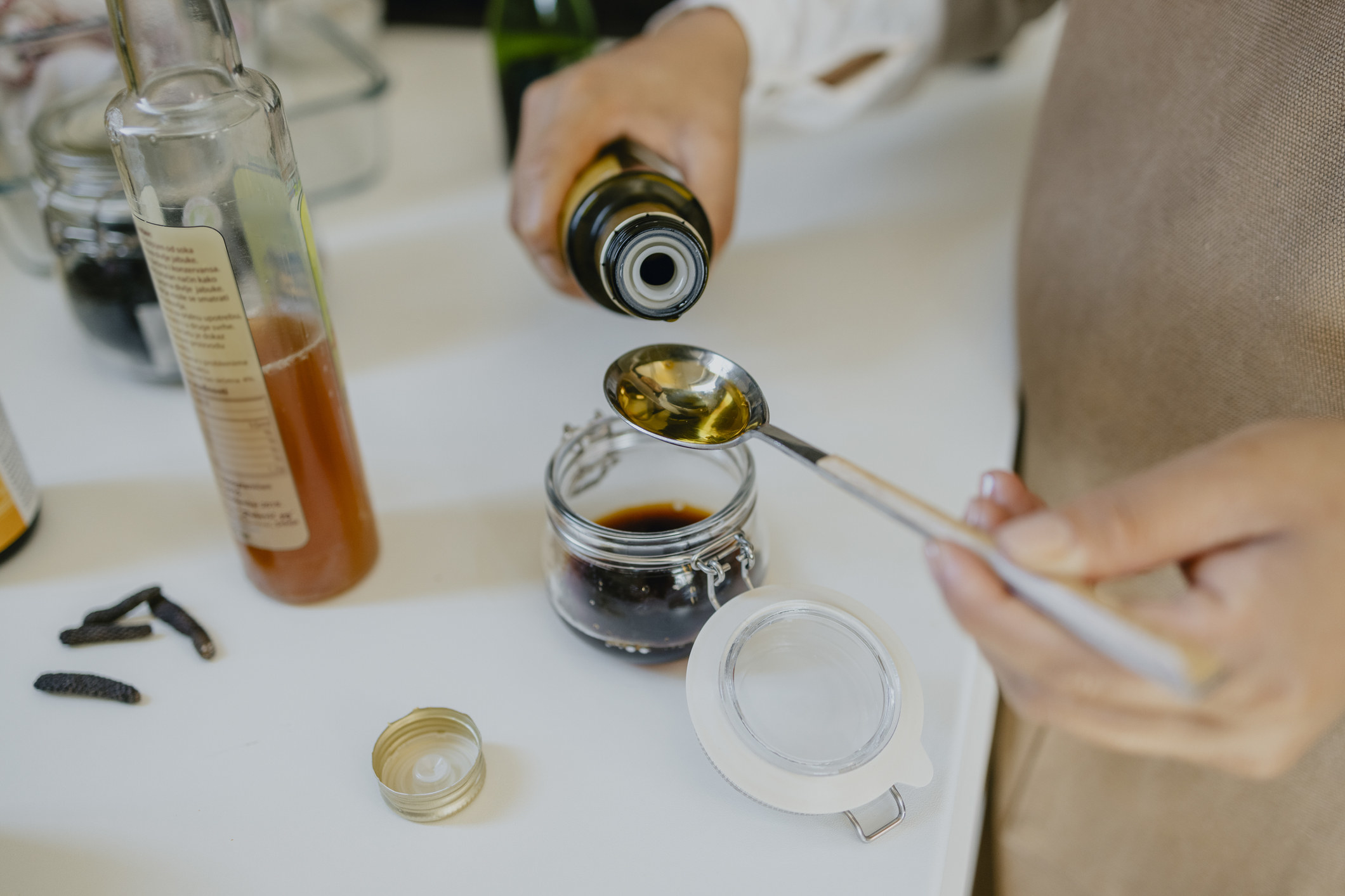 A person making homemade salad dressing.