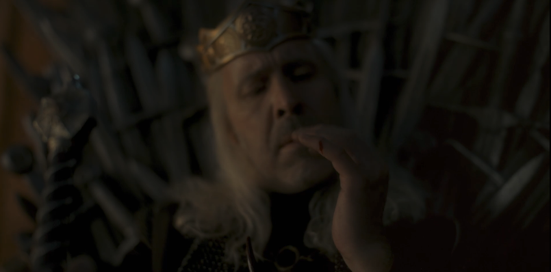 Viserys looking at the cut on his hand