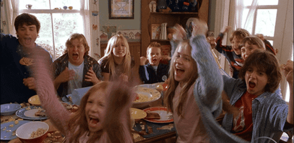The Baker kids cheer while they are seated together for a meal in &quot;Cheaper by the Dozen&quot;
