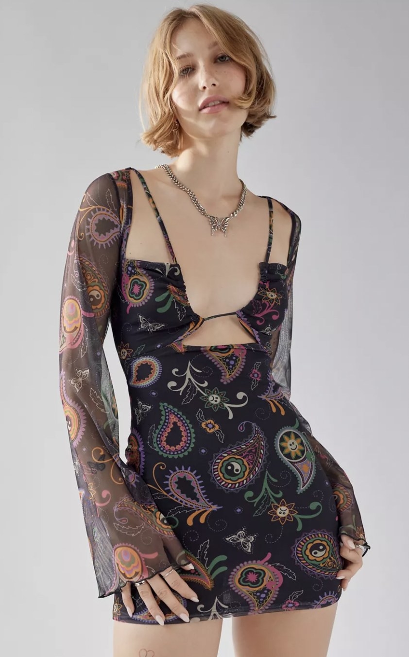 a model wearing the dress in black with mutli-colored paisley