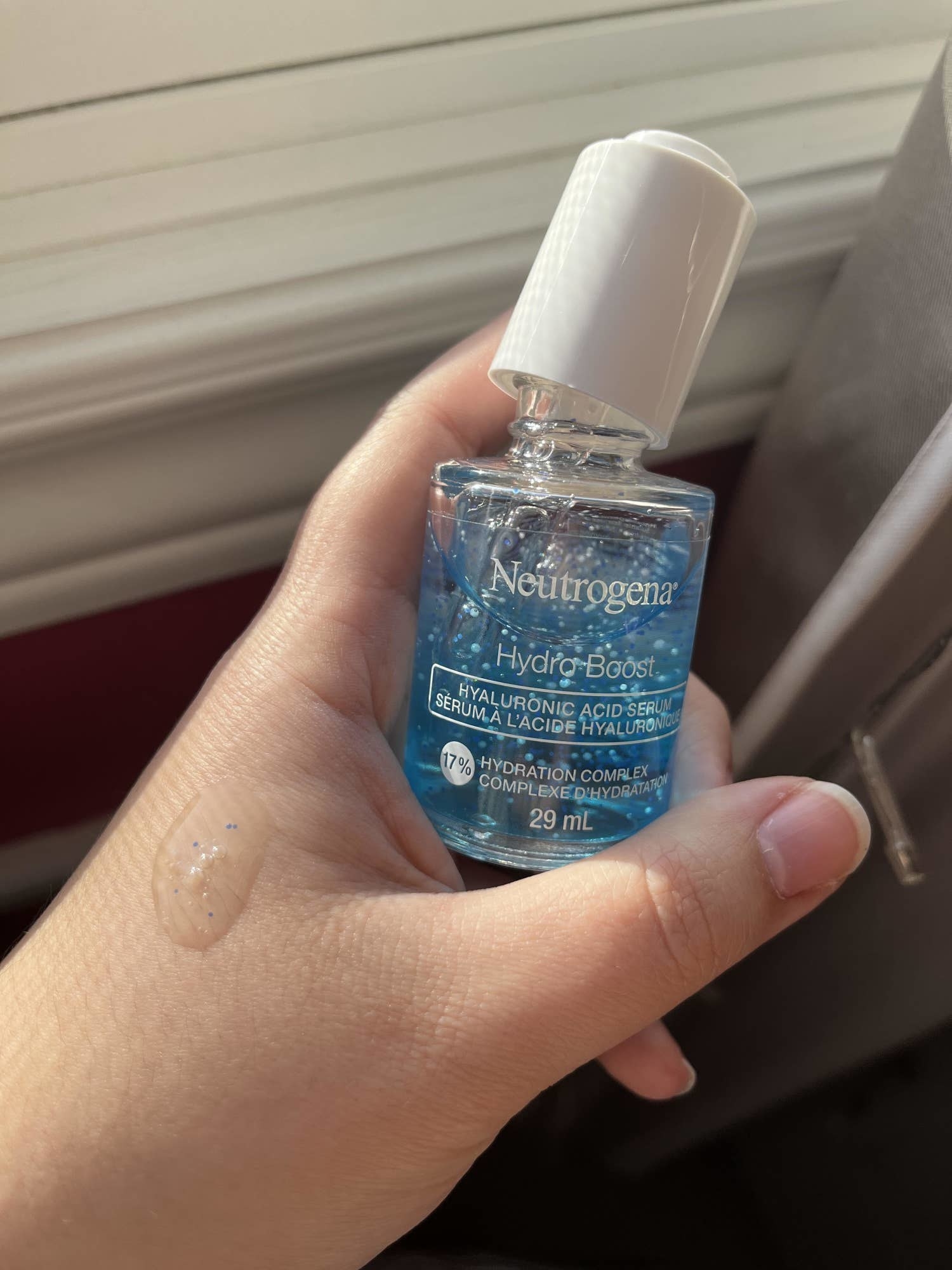 a person holding a bottle of neutrogena&#x27;s hydro boost serum