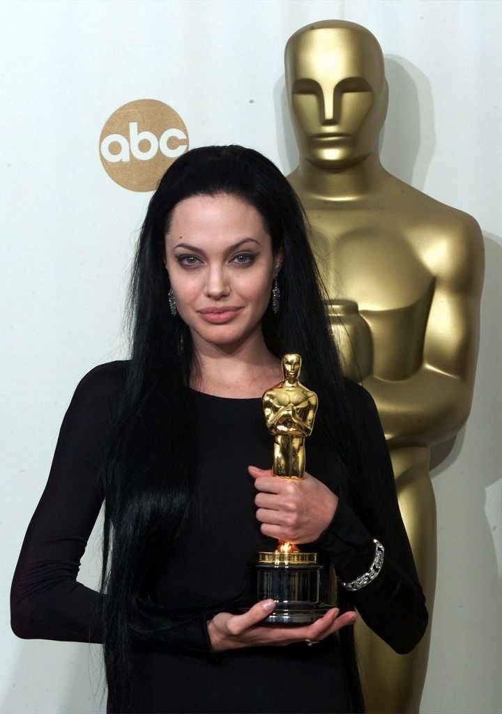 Angelina Jolie holding her Oscar