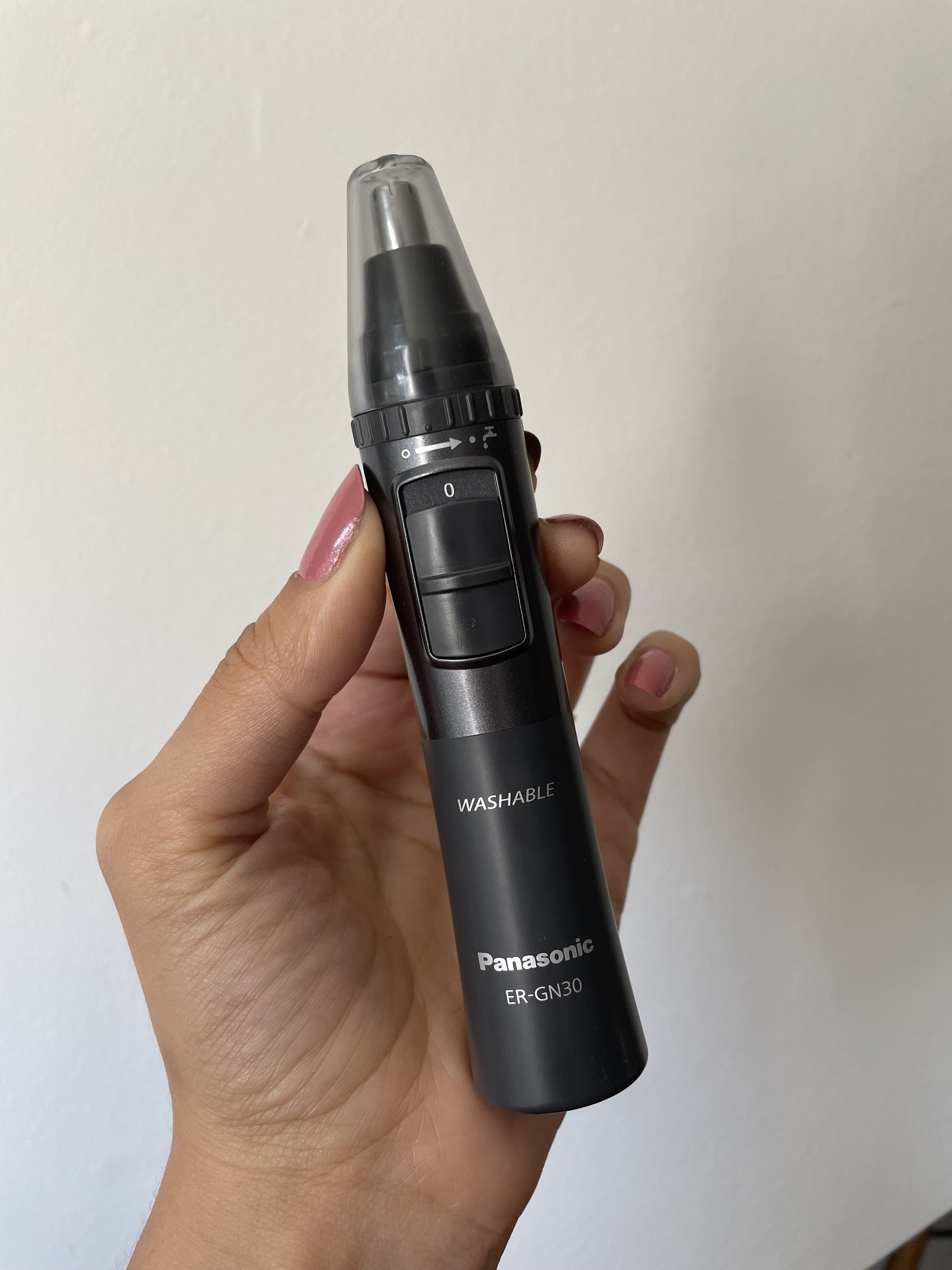 a person holding a nose trimmer