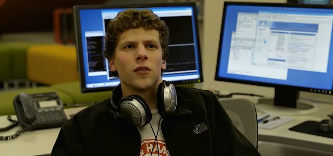 Mark sitting at a desk with headphones around his neck in &quot;The Social Network&quot;