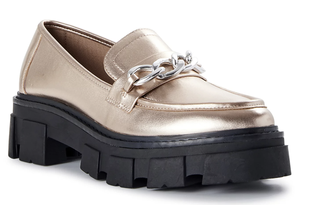 cream loafers with a black lug sole and silver chain