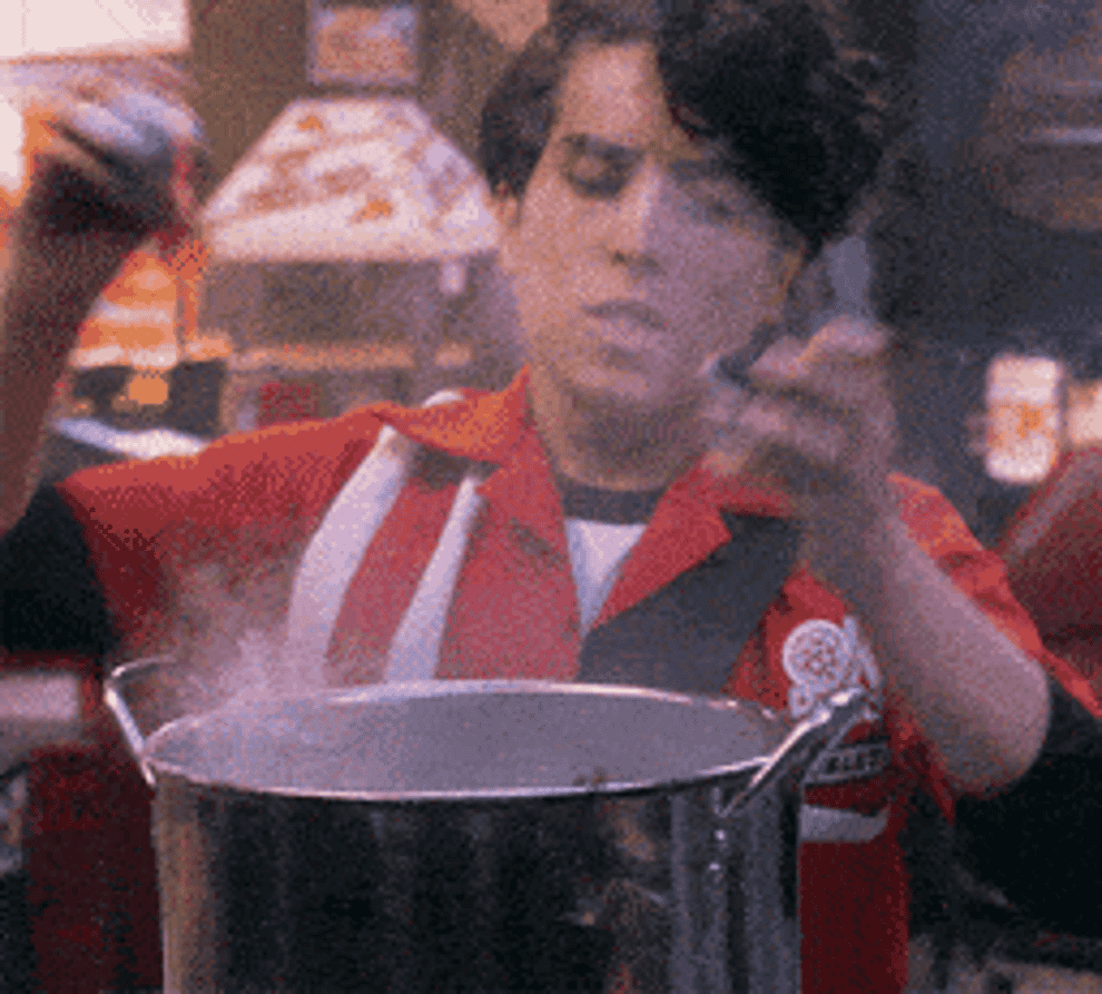 gif of someone pouring seasoning in a pot