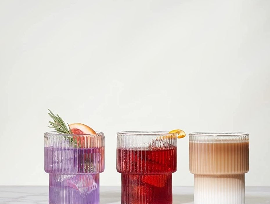 a set of three ribbed glasses filled with different drinks