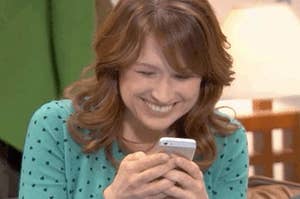 A close up of Erin Hannon as she smiles at her phone