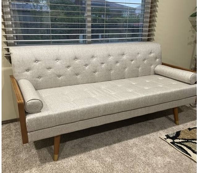 the beige and wood sofa