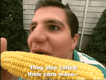 A man eagerly eating corn