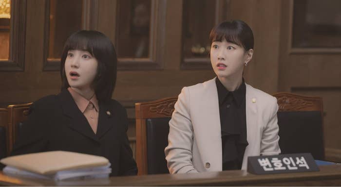 two characters from an Asian show in an office