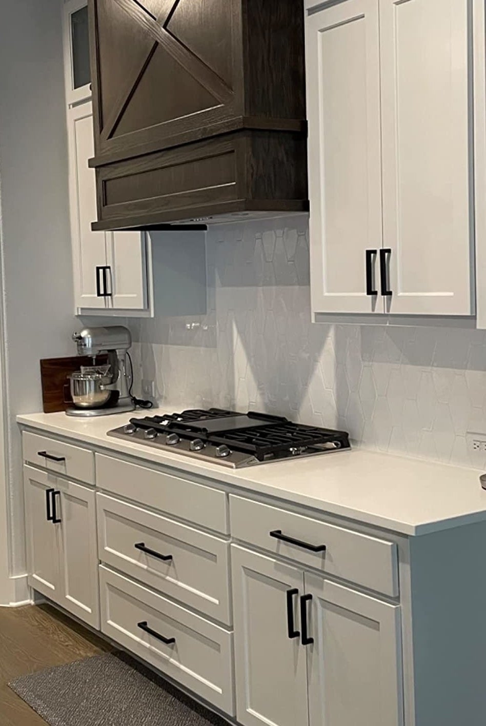 Reviewer image of black pulls on white kitchen cabinets