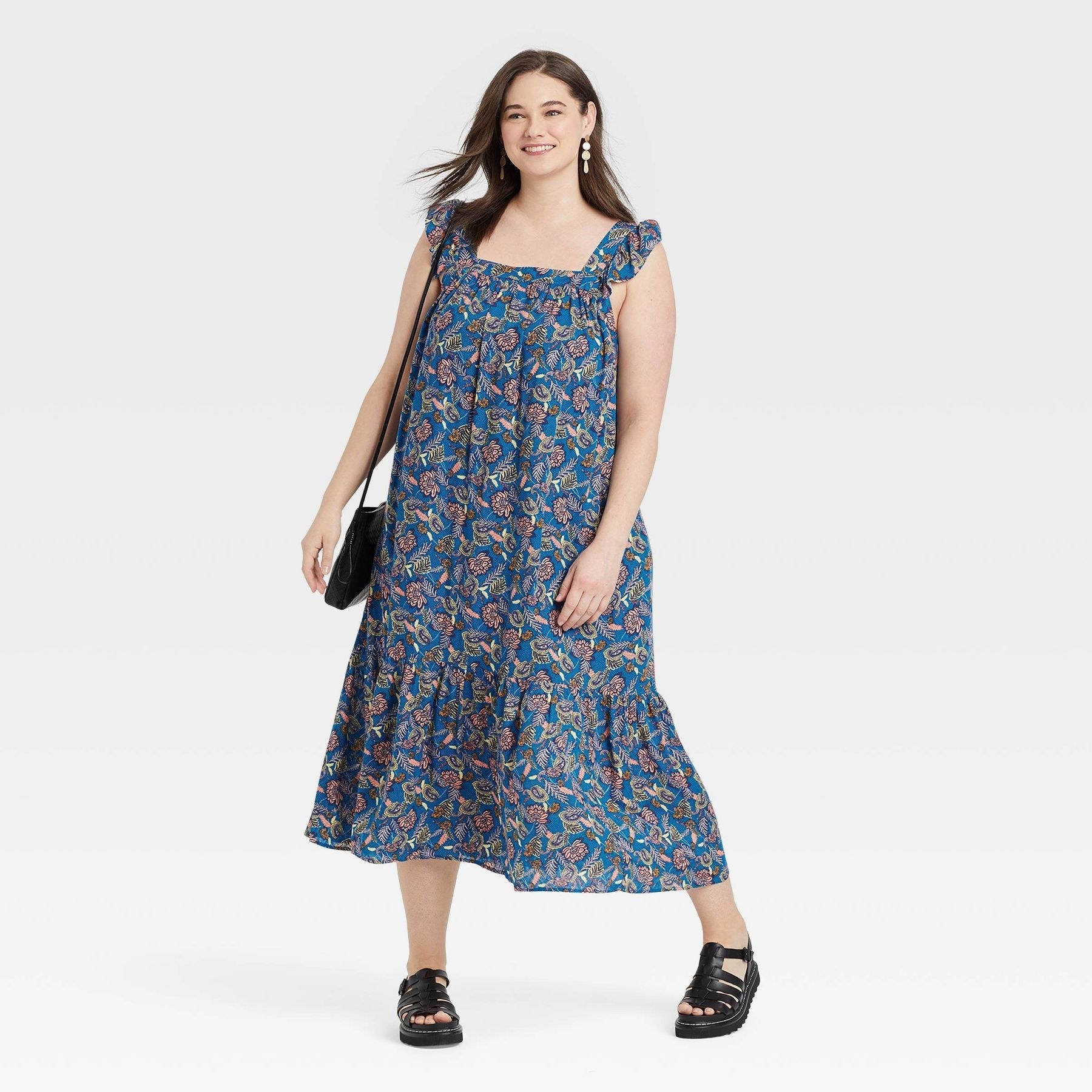 model wearing the blue floral midi dress
