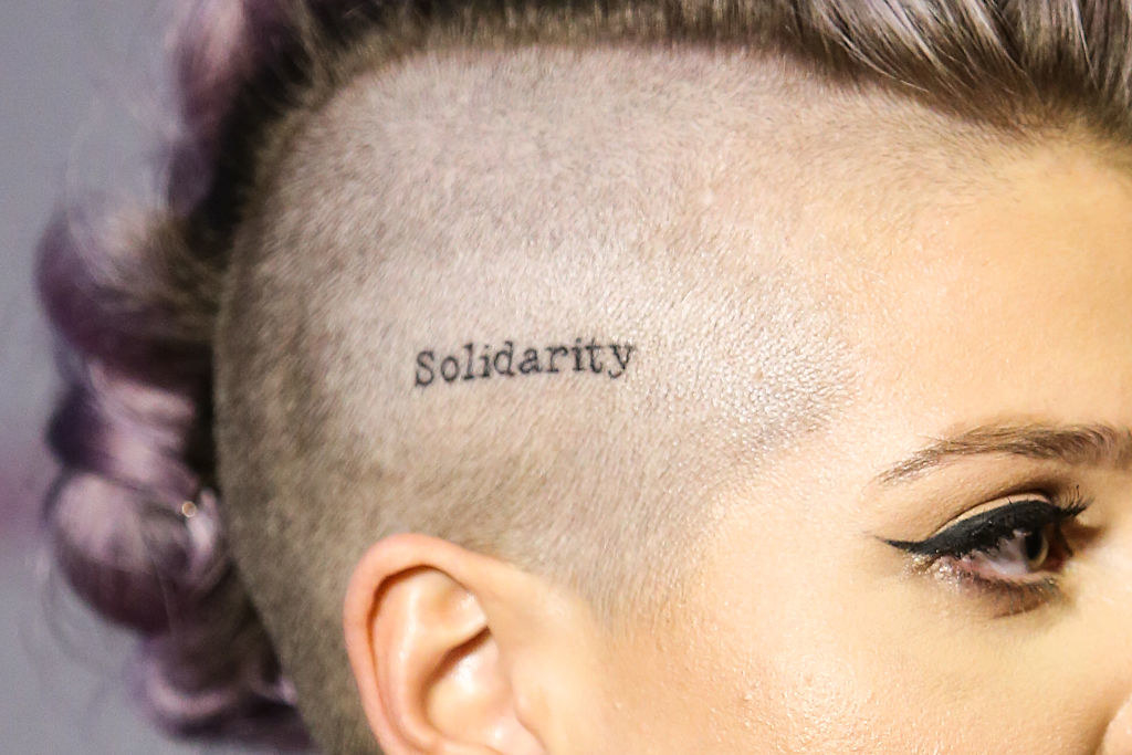 The word on the side of her head above her ear, visible with her mohawk