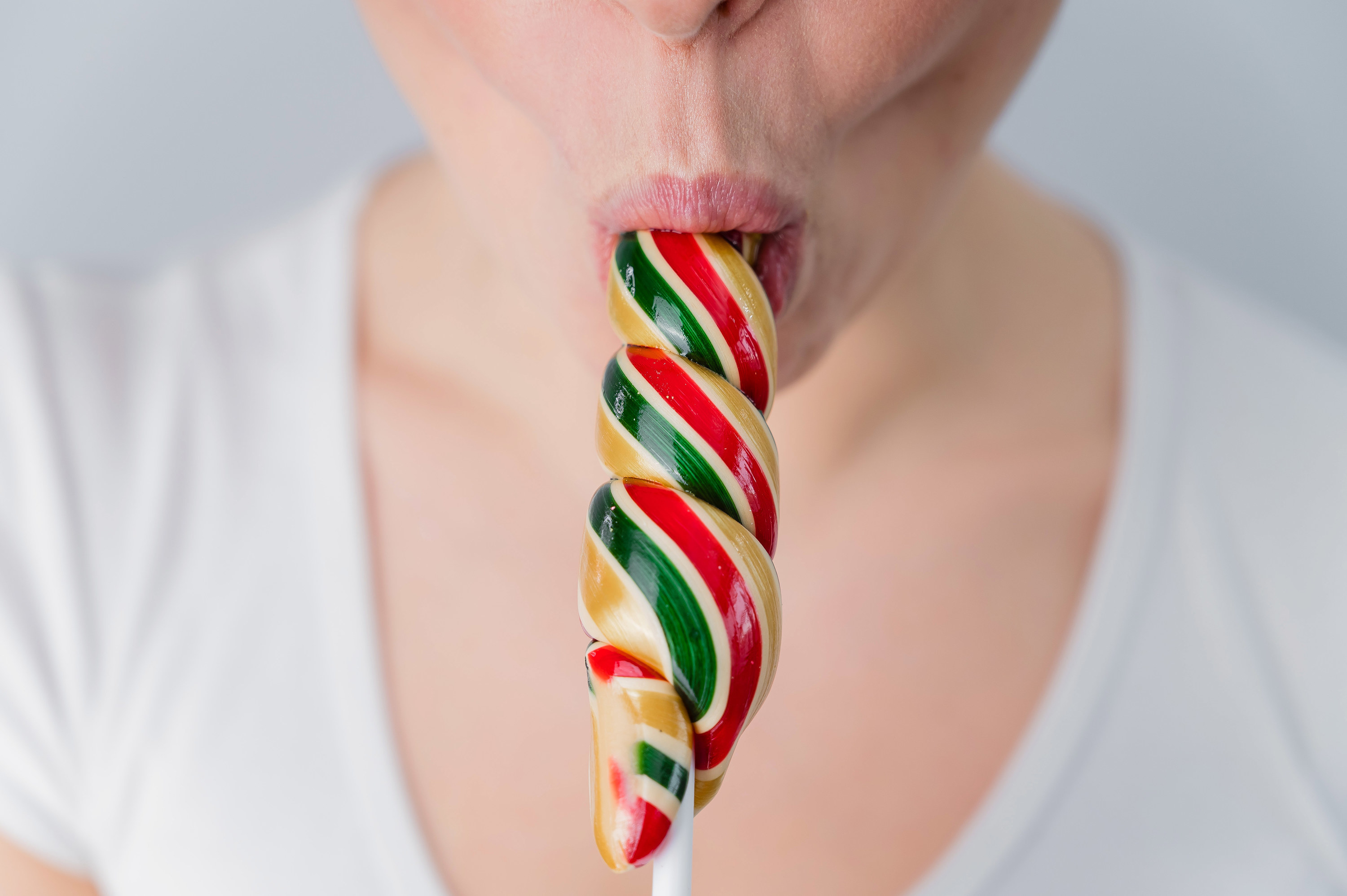 A woman sucking a lollipop