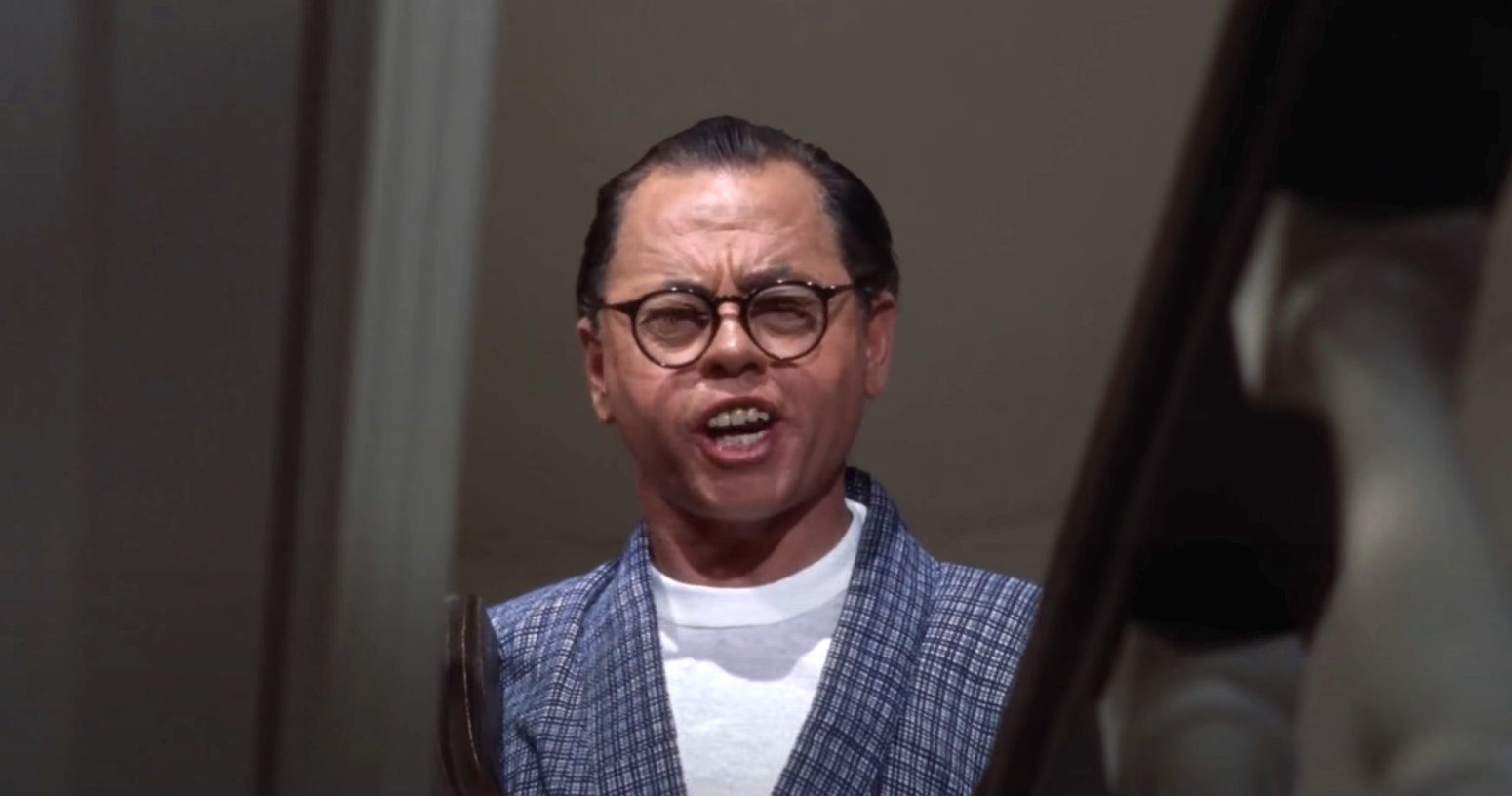 close up of Rooney playing the Asian character in the film