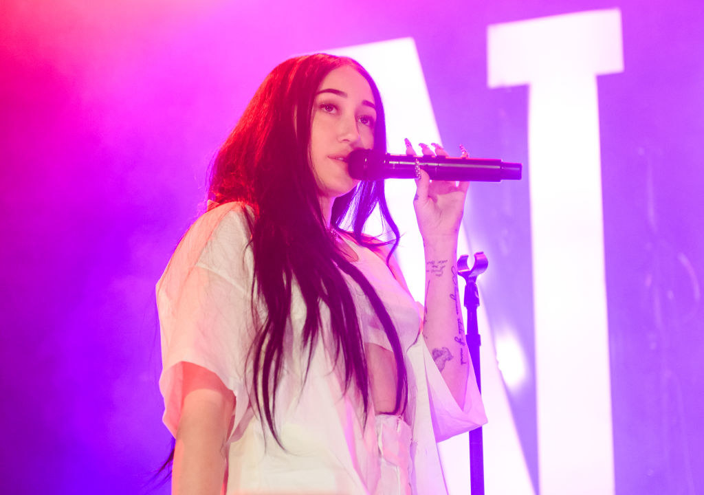 noah cyrus performing on stage at a concert