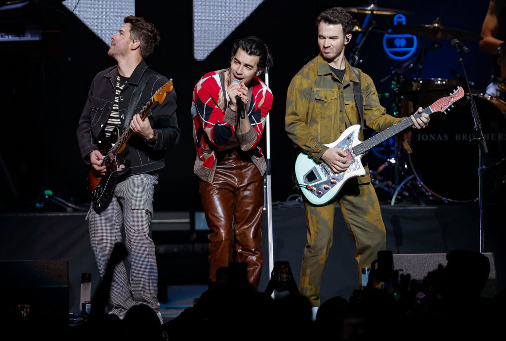 the jonas brothers performing on stage at jingle ball