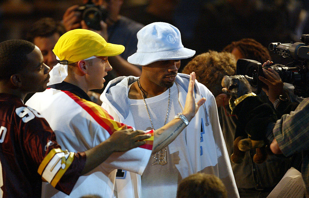 Eminem holding his hand up in front of Triumph the Insult Comic Dog
