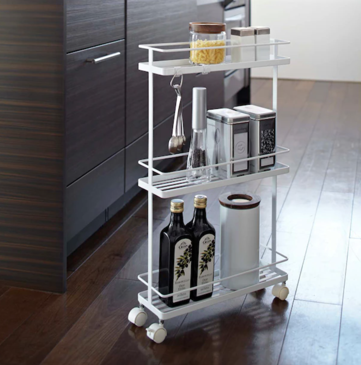 a rolling storage rack filled with kitchen accessories