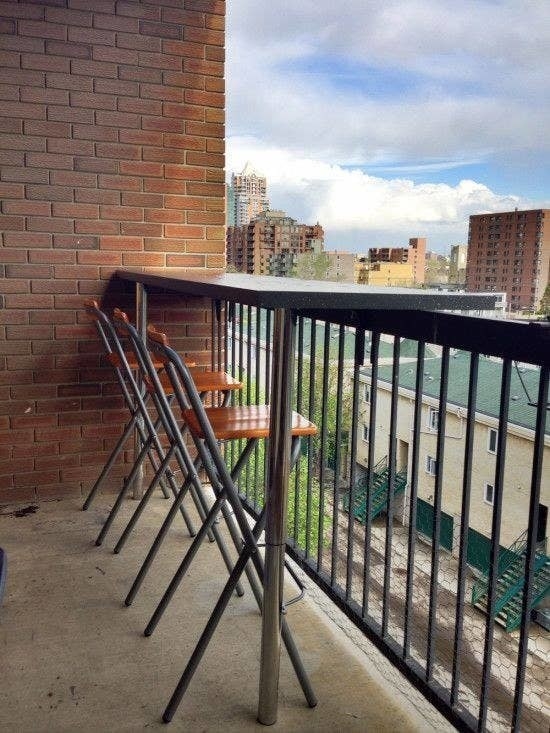 tall bar top placed on the balcony ledge