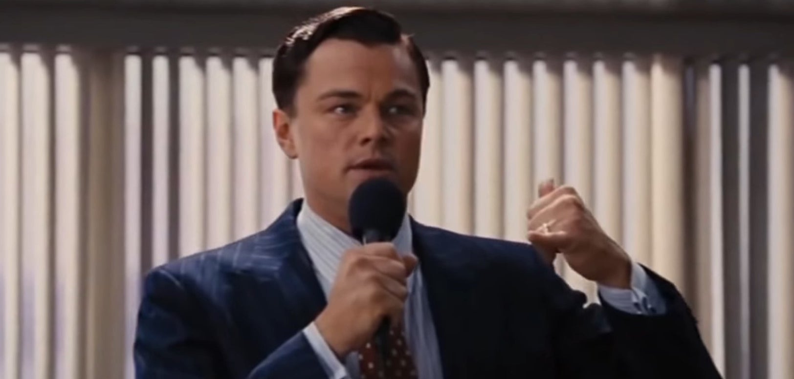 Jordan Belfort holding a microphone in &quot;The Wolf of Wall Street&quot;