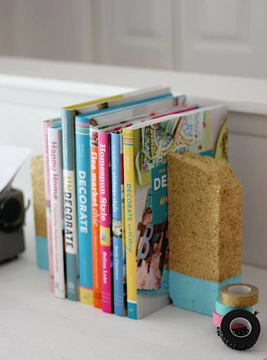 gold and teal painted bricks on a bookshelf